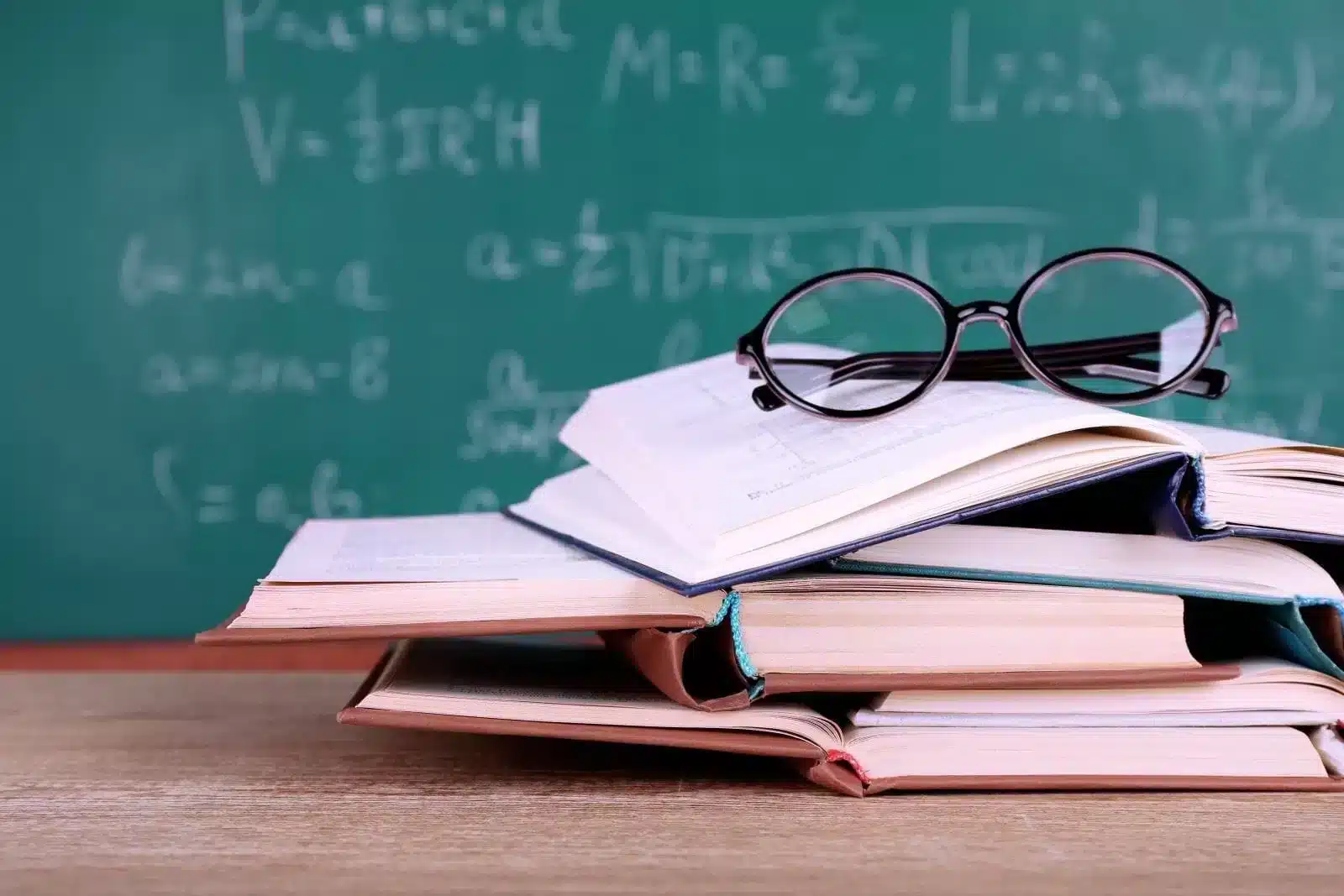 Stacks of books with glasses on top