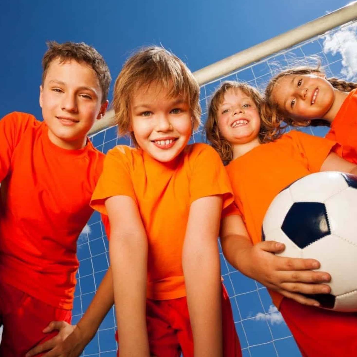 4 kids playing football