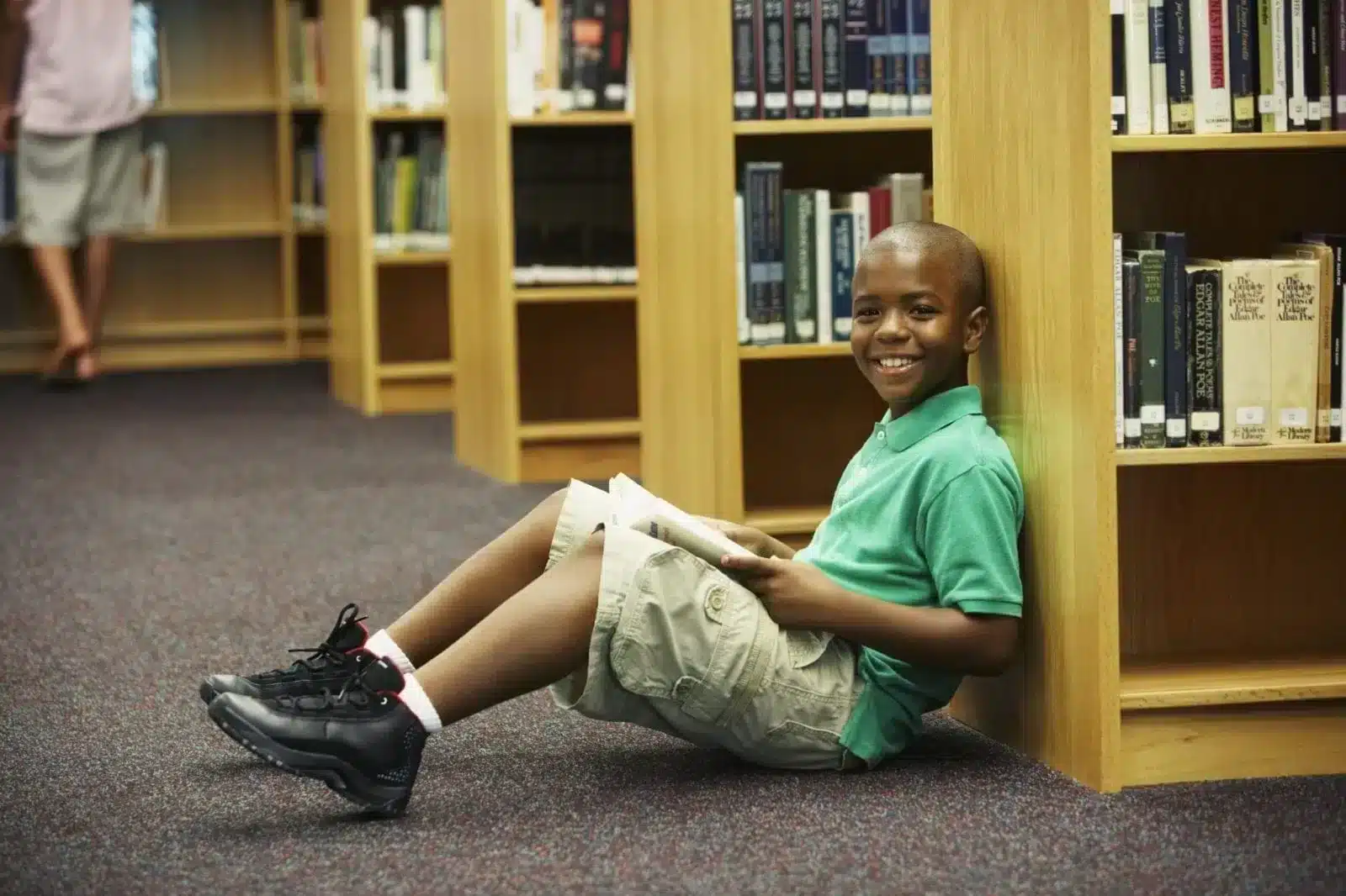 A boy readomg book at library