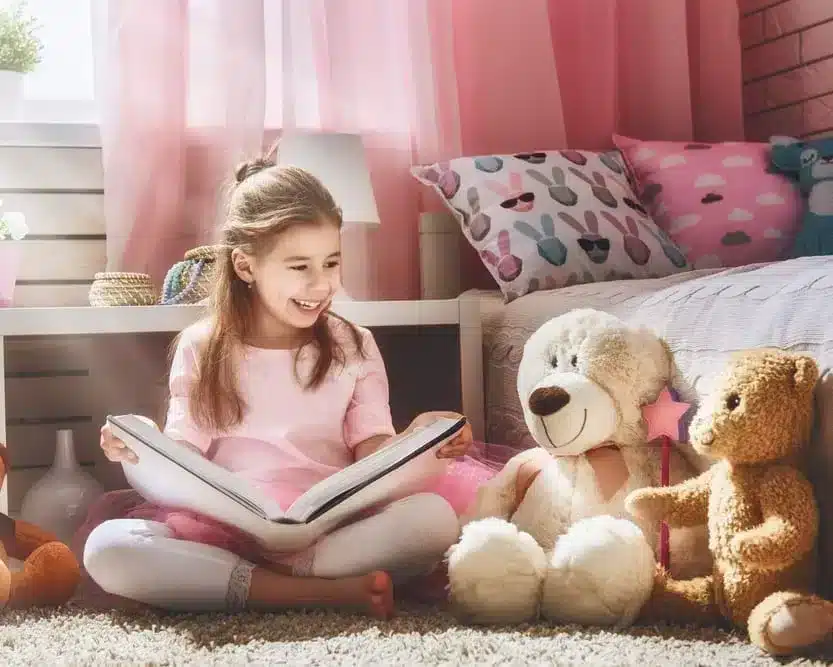 Young girl reading book happily with his bear dolls