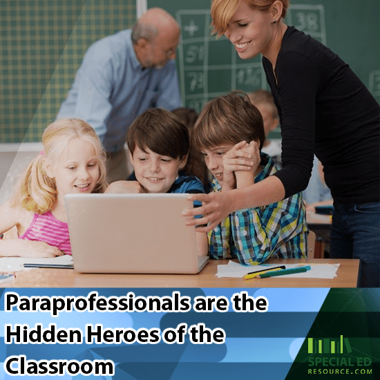 3 students sitting around a computer getting support from their paraprofessionals in their classroom at school.