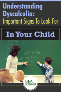 Young boy with dyscalculia standing at the chalkboard with his teacher in an elementary classroom struggling with a math problem.