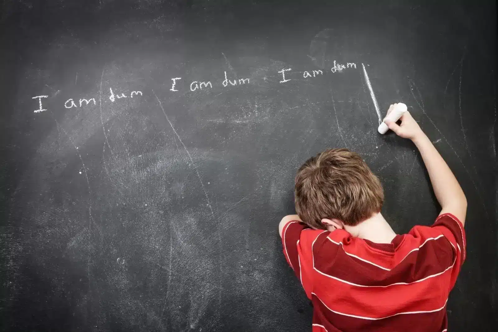 Child-writing-dum-on-the-board