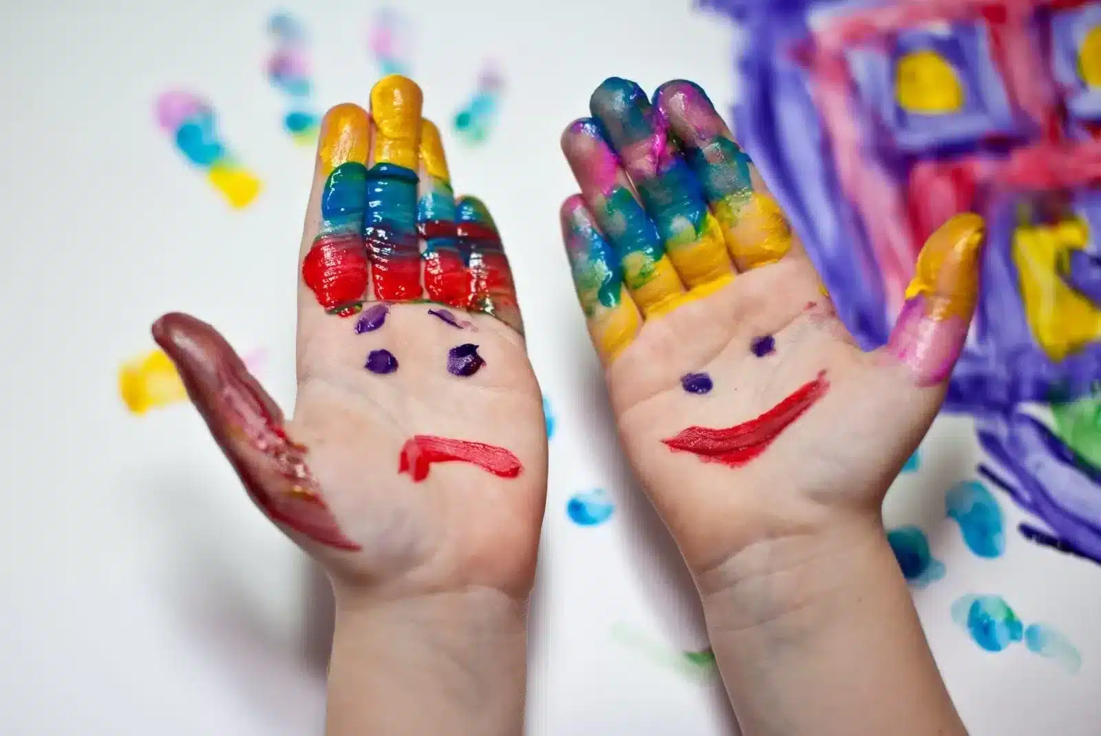 Painting smile and sad gesture on hands