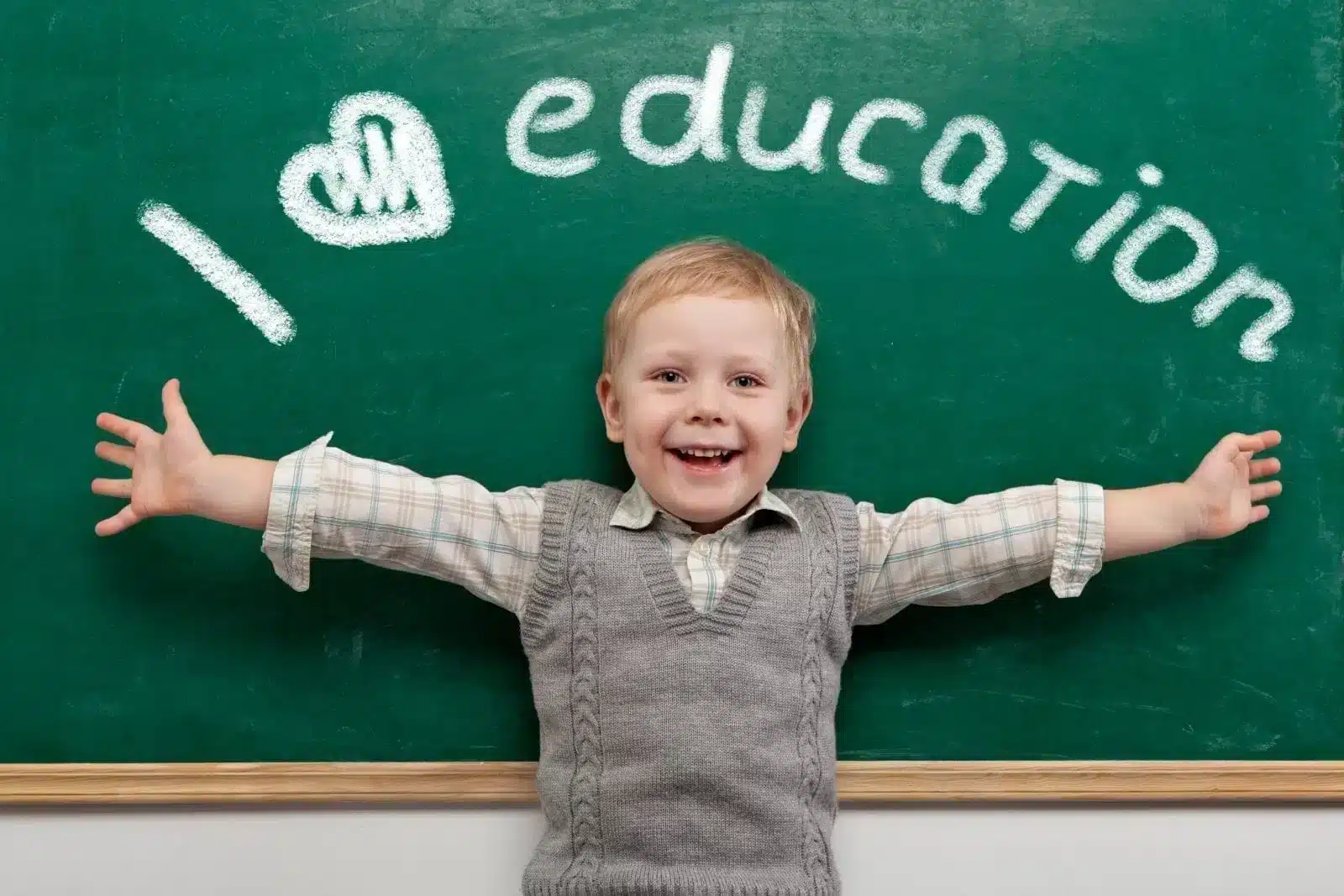 Happy boy with chalkboard with text i love education