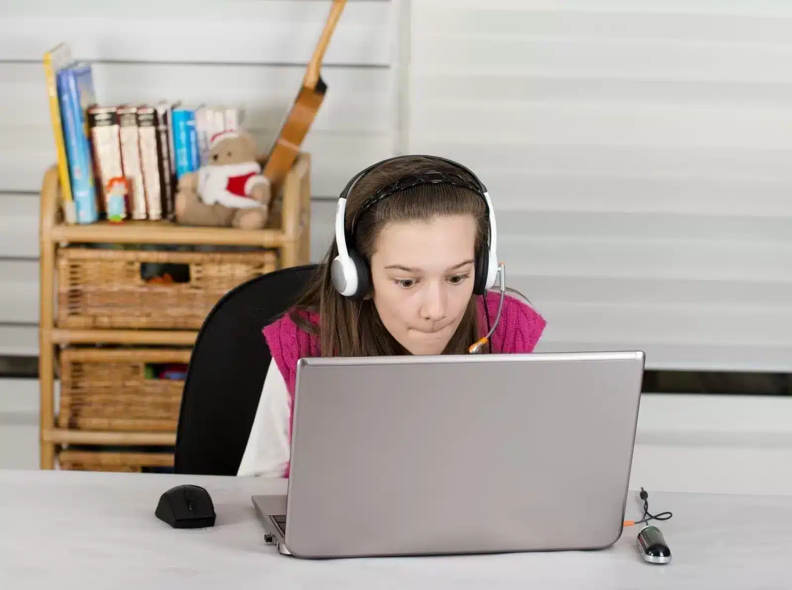 Girl using a laptop and using headset