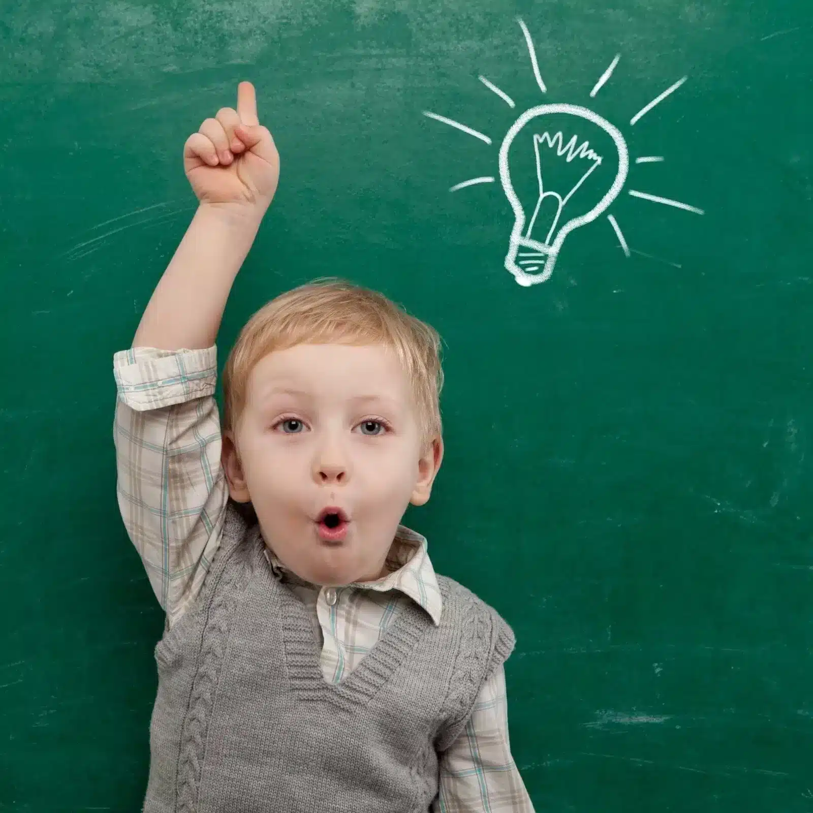 Little-boy-raising-his-hand-with-chalkboard