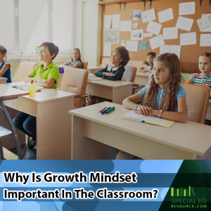 Elementary classroom of students sitting at their desks while their teacher does a growth mindset activity