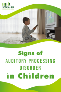 A young boy sits cross-legged on a fluffy rug, holding a remote and watching television, with a look of concentration. Text overlay reads 'Signs of Auditory Processing Disorder in Children' with the logo for SpecialEdResource.com at the bottom.